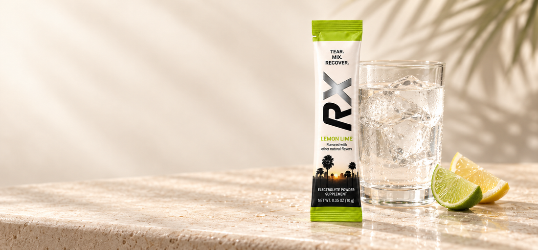 RYVEX Lemon Lime electrolyte stick beside a glass of water and citrus